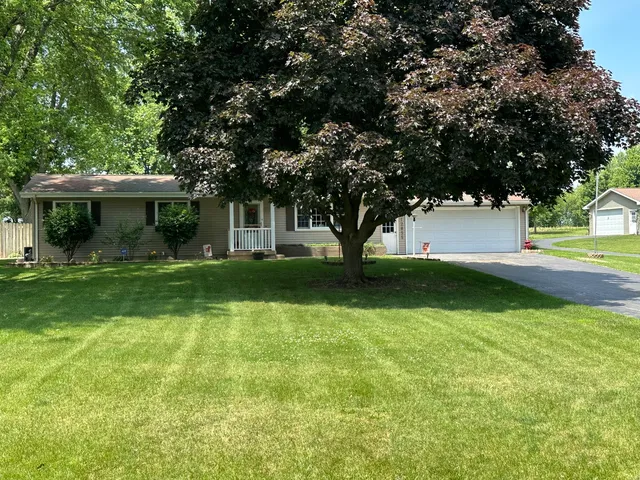 a view of house with yard