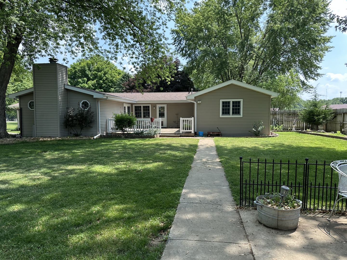 12855 Lawrence Road Sterling, IL 61081 - Photo 30 of 30 a front view of a house with a garden and trees