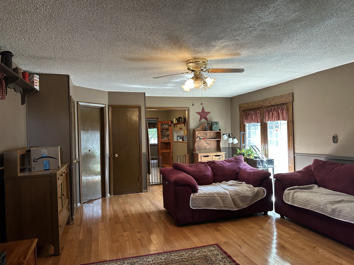 12855 Lawrence Road Sterling, IL 61081 - Photo 7 of 40 a living room with furniture ceiling fan and a wooden floor