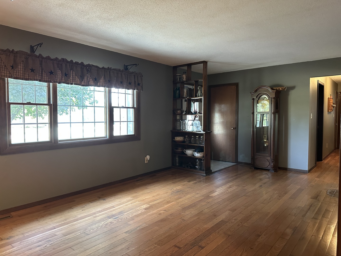 12855 Lawrence Road Sterling, IL 61081 - Photo 8 of 40 a view of an empty room with wooden floor and a window