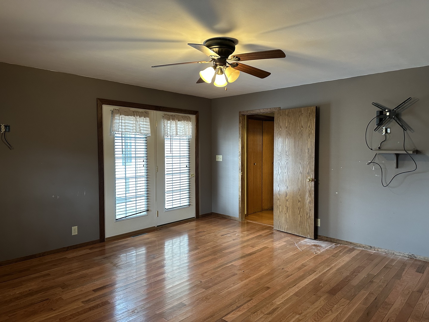 12855 Lawrence Road Sterling, IL 61081 - Photo 9 of 30 a view of an empty room with a window and wooden floor