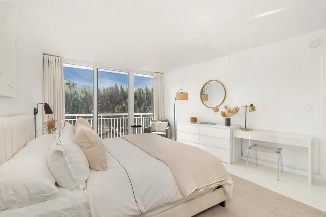 a bedroom with a large bed and a large window