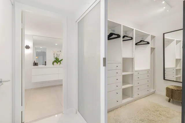 a bathroom with a shower and a mirror