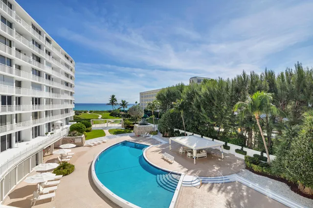 a view of a patio with a table and chairs under an umbrella