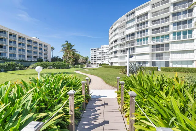 a living room with fireplace furniture and floor to ceiling window