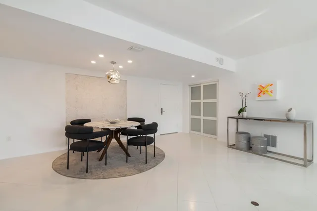 a dining room with furniture and wooden floor