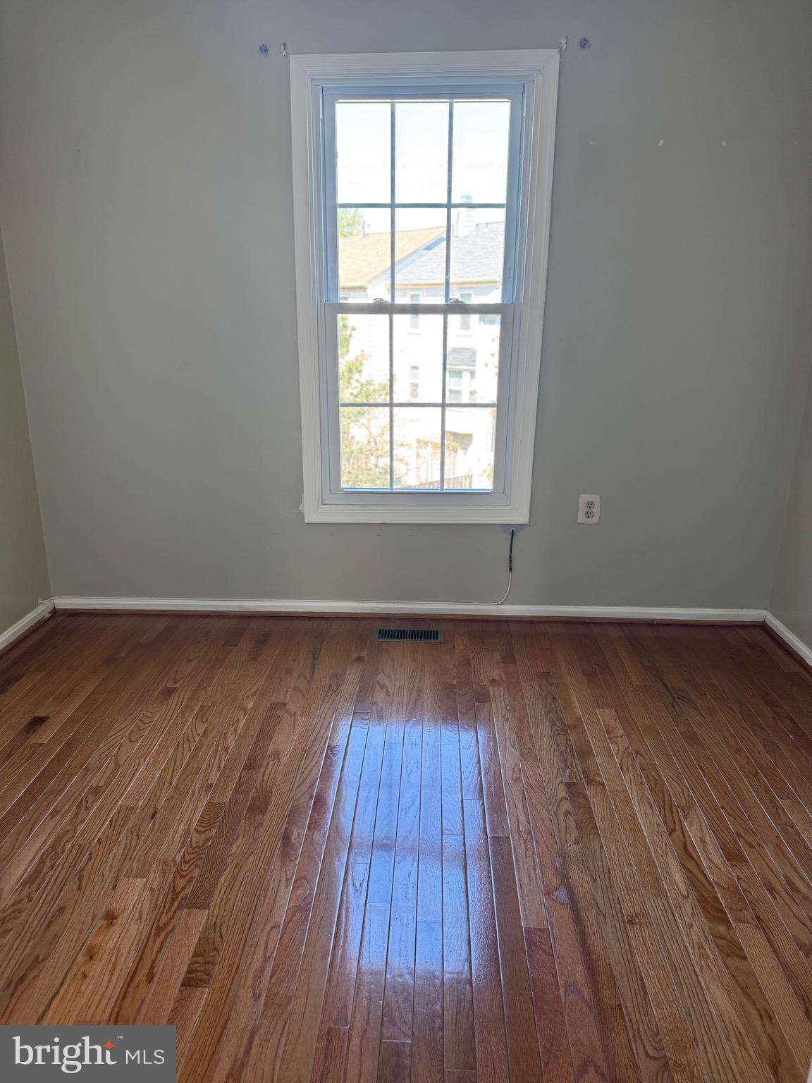 10424 Bermuda Lane Manassas, VA 20109 - Photo 14 of 32 an empty room with wooden floor and windows
