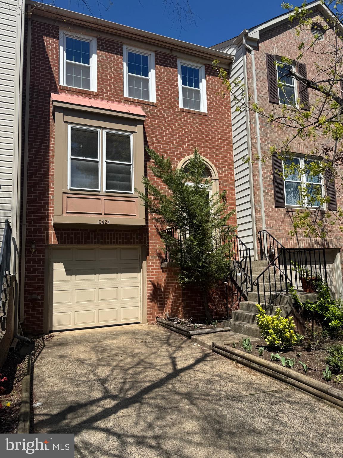 10424 Bermuda Lane Manassas, VA 20109 - Photo 2 of 32 a front view of a house with a yard and a garage