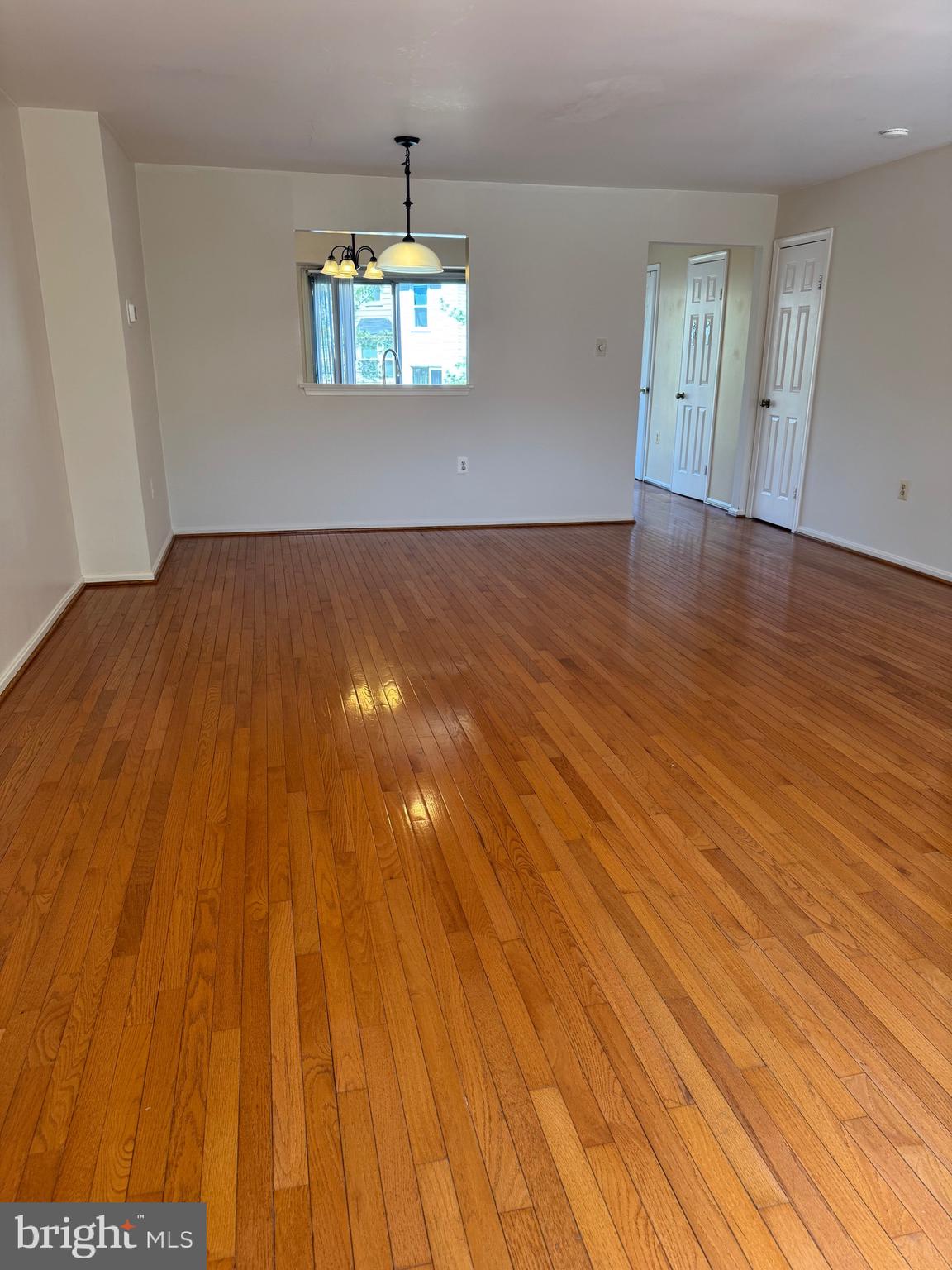 10424 Bermuda Lane Manassas, VA 20109 - Photo 7 of 32 an empty room with wooden floor and windows