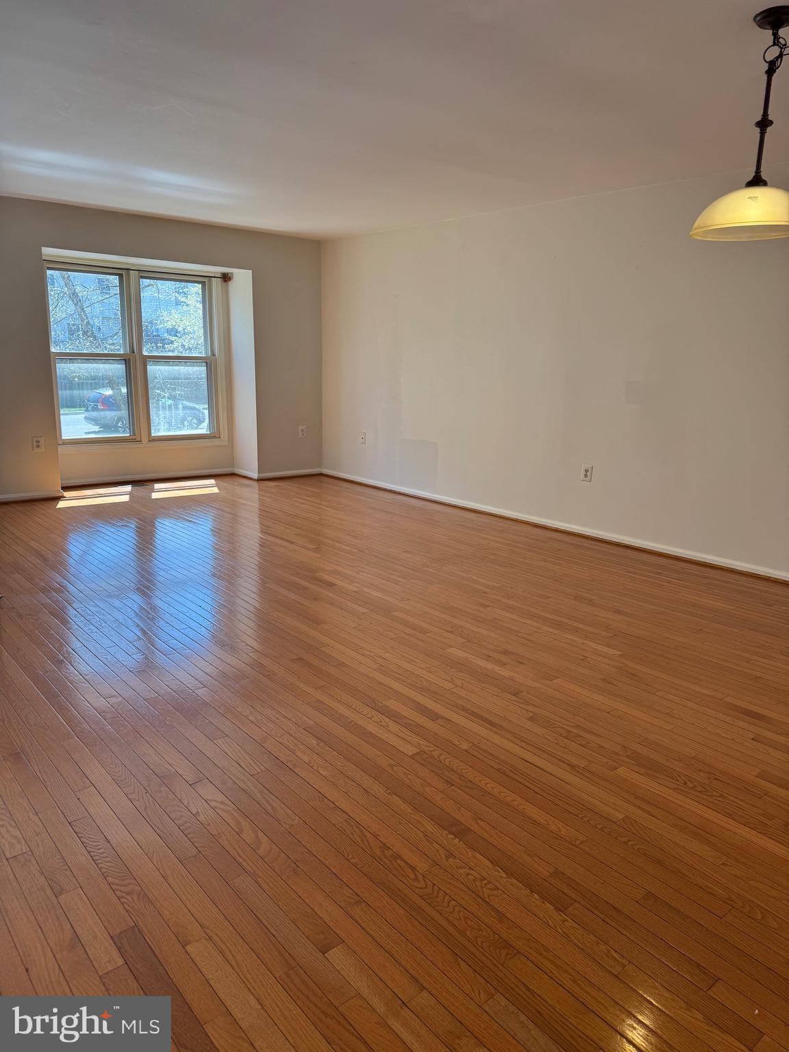 10424 Bermuda Lane Manassas, VA 20109 - Photo 8 of 32 an empty room with wooden floor and windows