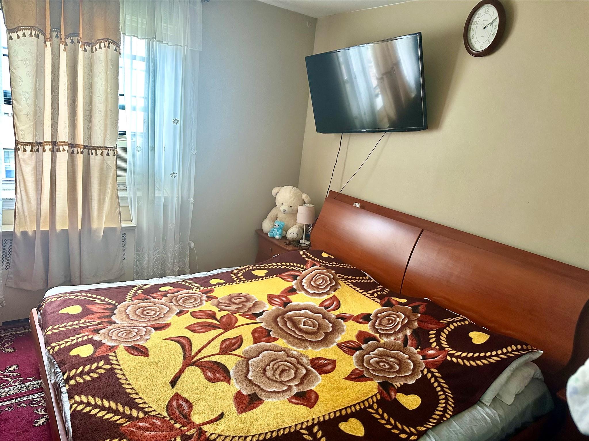 147-11 79th Avenue, Unit 3L Queens, NY 11367 - Photo 11 of 13 a bedroom with a bed and window