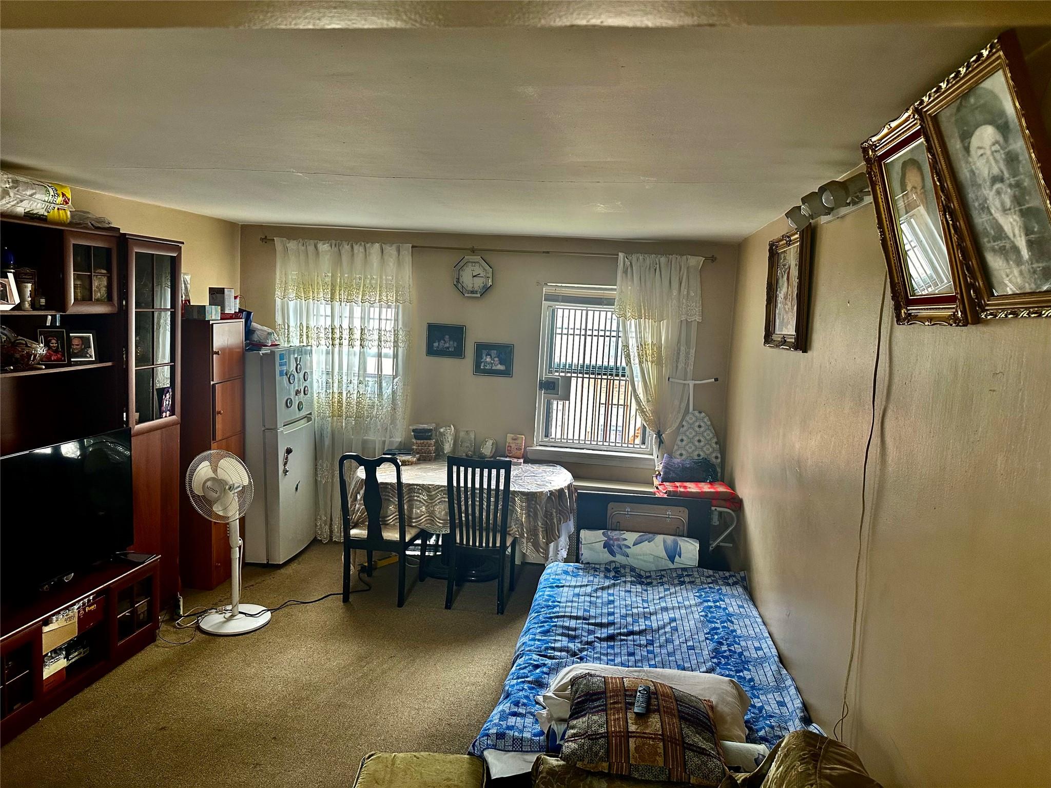 147-11 79th Avenue, Unit 3L Queens, NY 11367 - Photo 4 of 13 a living room with furniture and a flat screen tv