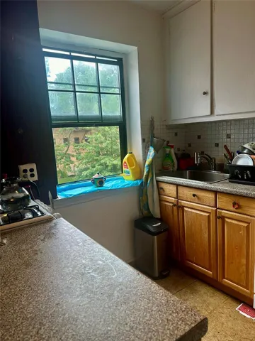 a kitchen with stainless steel appliances granite countertop a sink stove and cabinets