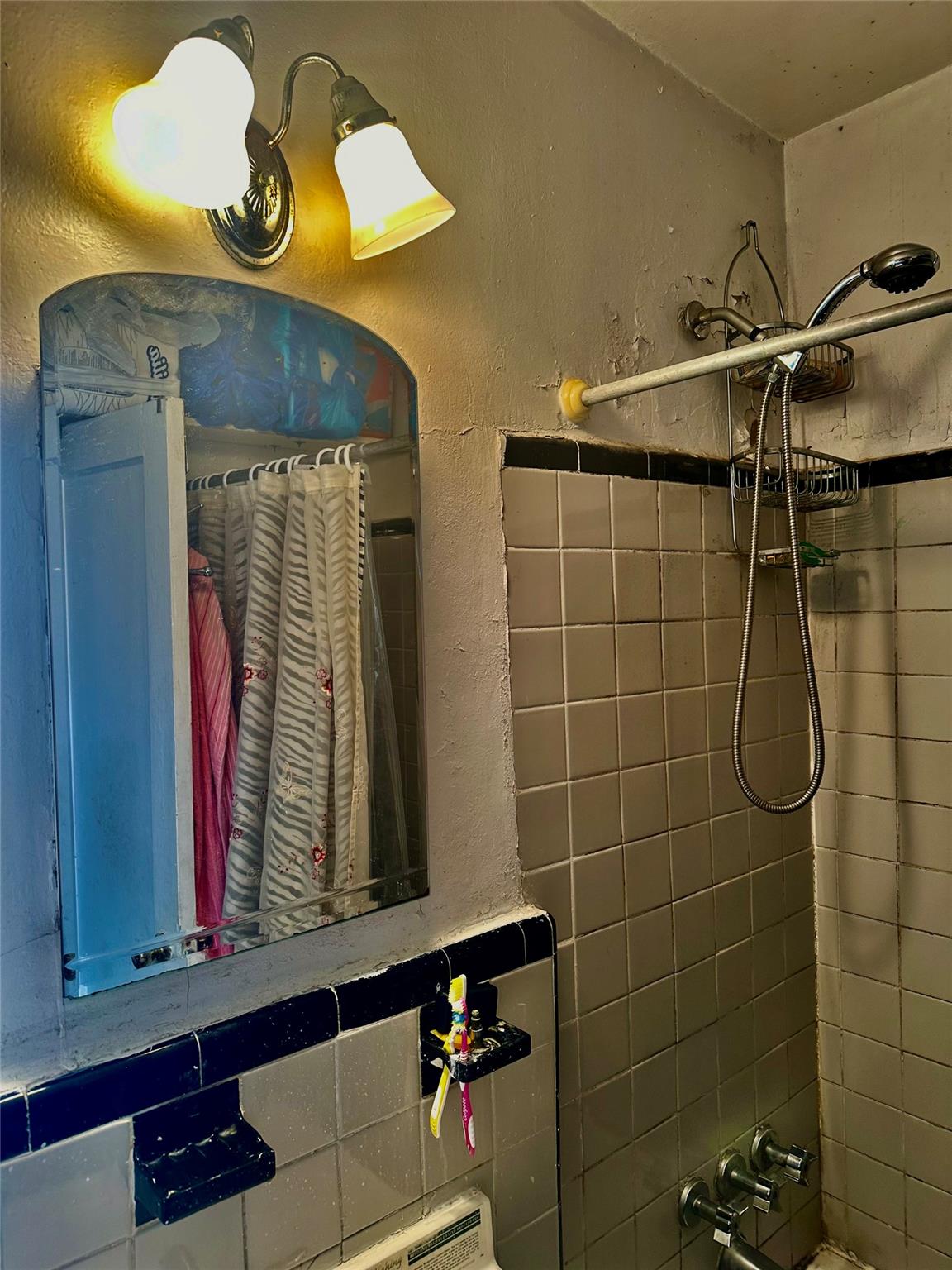 147-11 79th Avenue, Unit 3L Queens, NY 11367 - Photo 10 of 13 a bathroom with a sink and a mirror
