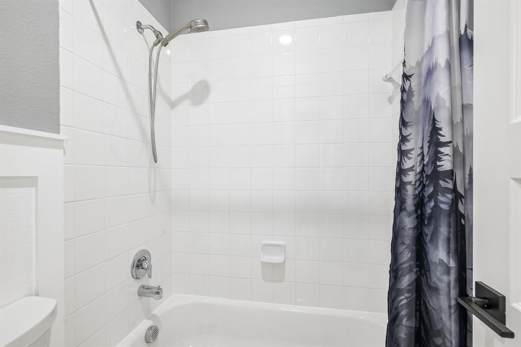 1805 Huntsman Way Forney, TX 75126 - Photo 24 of 34 White subway tile shower surround with chrome fixtures and a built-in soap dish