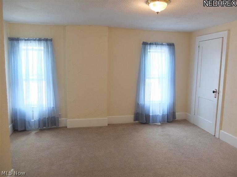 Master bedroom with new carpet and walk-in closet.