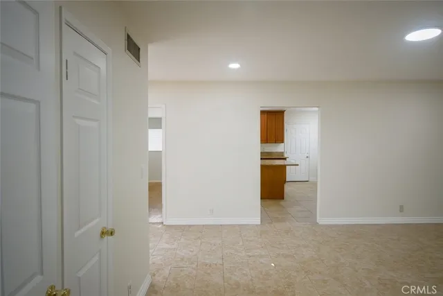 a view of a hallway with a kitchen