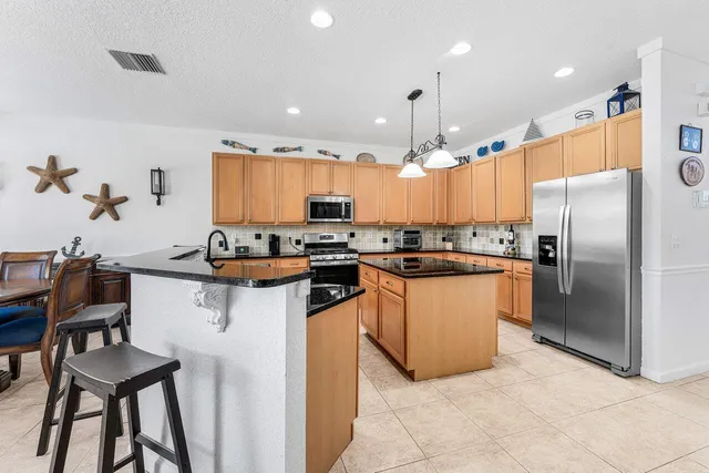 a living room with furniture and kitchen view