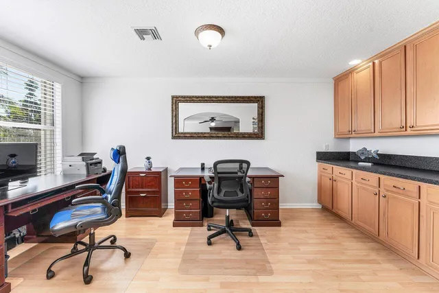 a bathroom with a toilet sink vanity and mirror