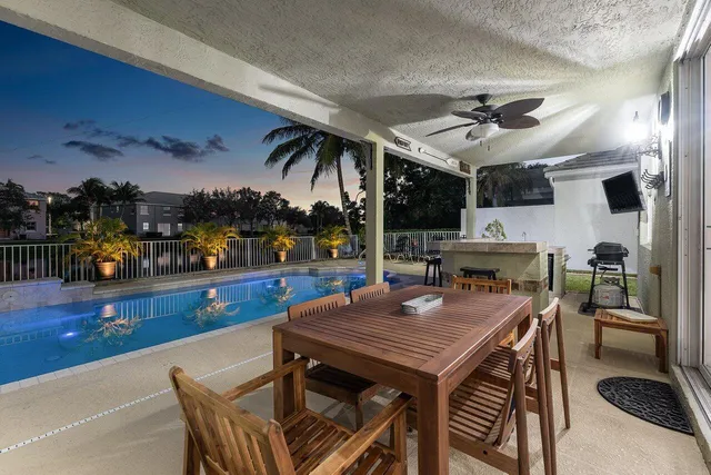 a swimming pool with outdoor seating and plants