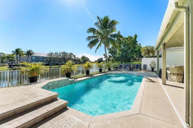 a view of a swimming pool with seating area