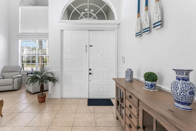 a kitchen with stainless steel appliances granite countertop a stove top oven a sink a counter top space cabinets and a window