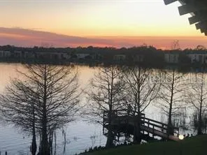a view of lake with sunset
