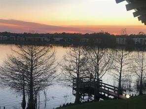 568 Orange Drive, Unit 48 Altamonte Springs, FL 32701 - Photo 3 of 7 a view of lake with sunset