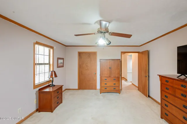 wooden floor chandelier and windows in a room