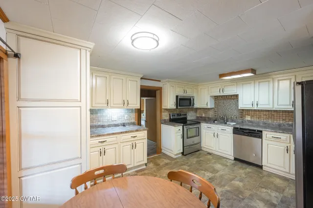 a kitchen with a sink stove and refrigerator