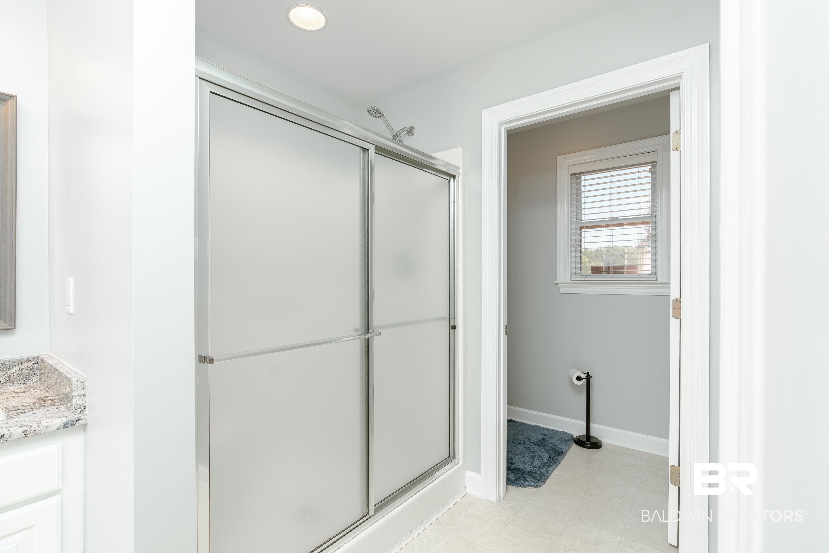 9477 Deerfield Drive Irvington, AL 36544 - Photo 23 of 58 Bathroom with an enclosed shower, vanity, and tile patterned floors