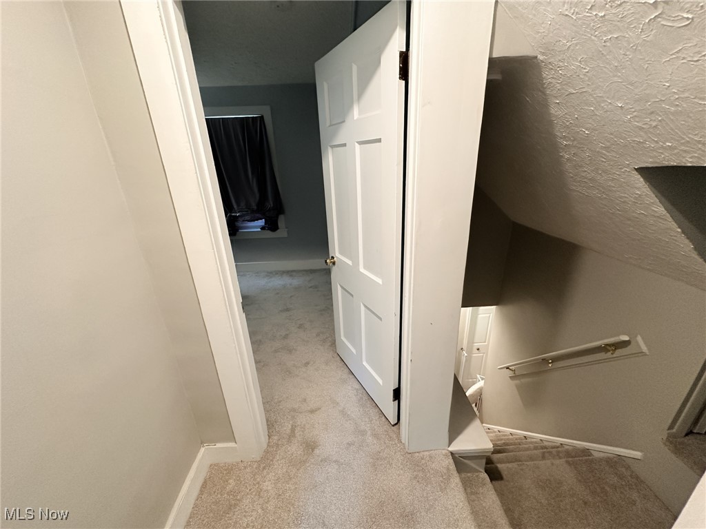 8145 Chagrin Road Chagrin Falls, OH 44023 - Photo 26 of 40 Hallway with light colored carpet and a textured ceiling