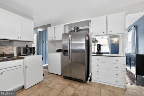 a kitchen with cabinets stainless steel appliances and counter space