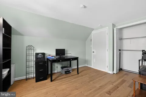 a view of a workspace with furniture and wooden floor