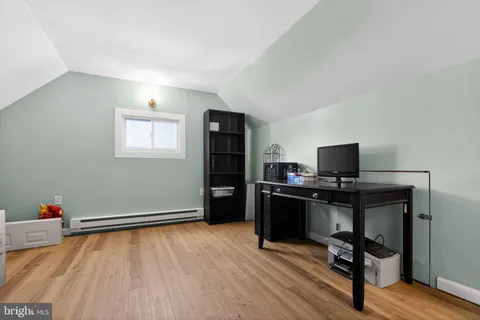 a view of a workspace with furniture and a window