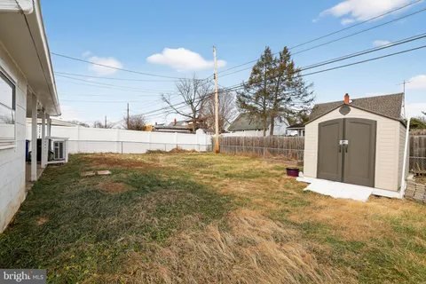 a view of a yard with a large tree