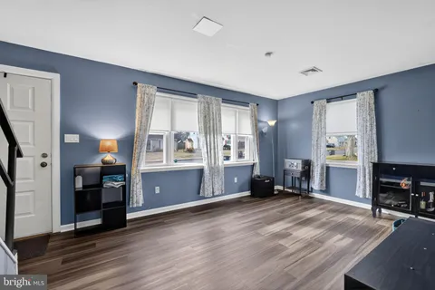 a view of a livingroom with furniture hardwood floor and staircase