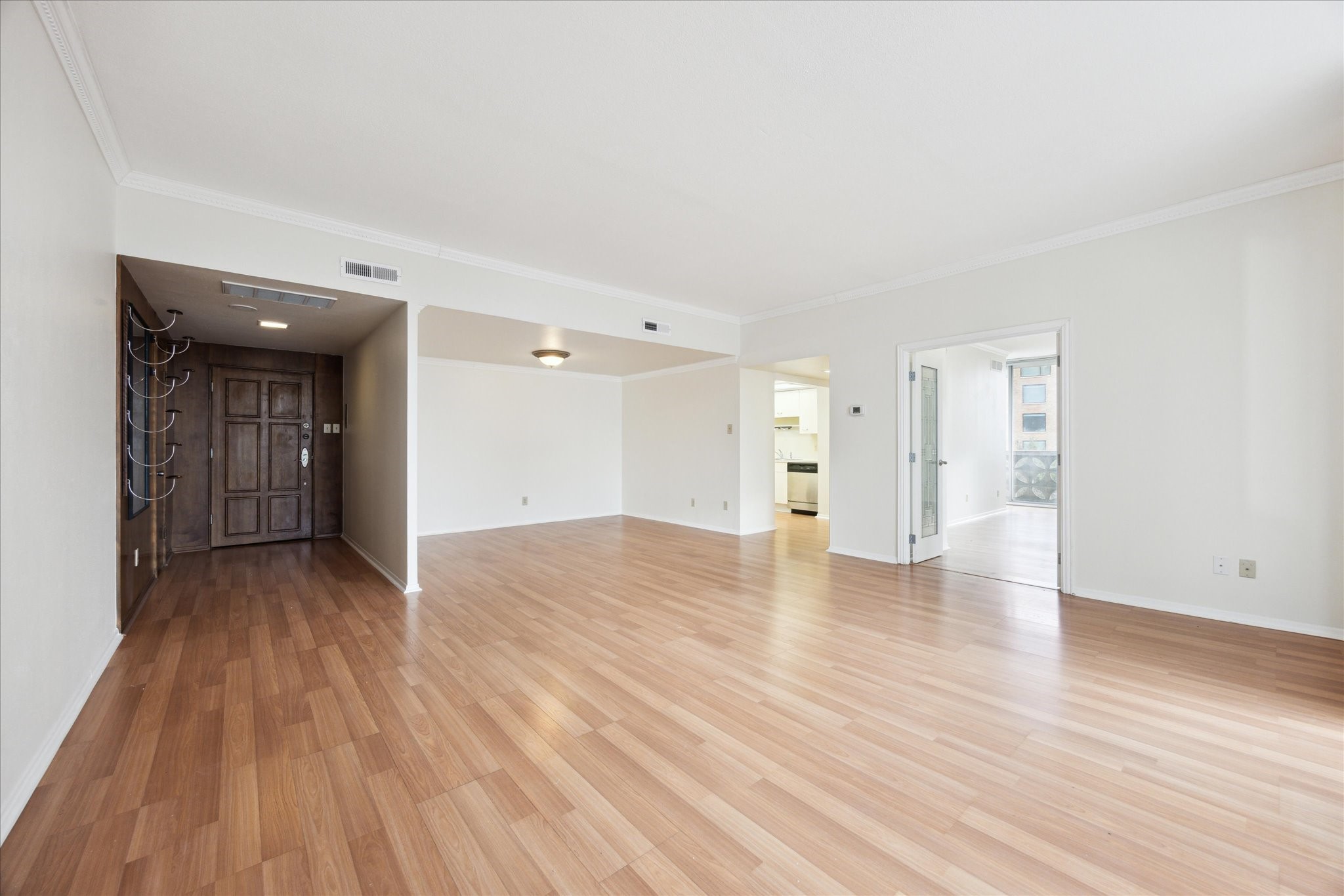 a view of empty room with wooden floor