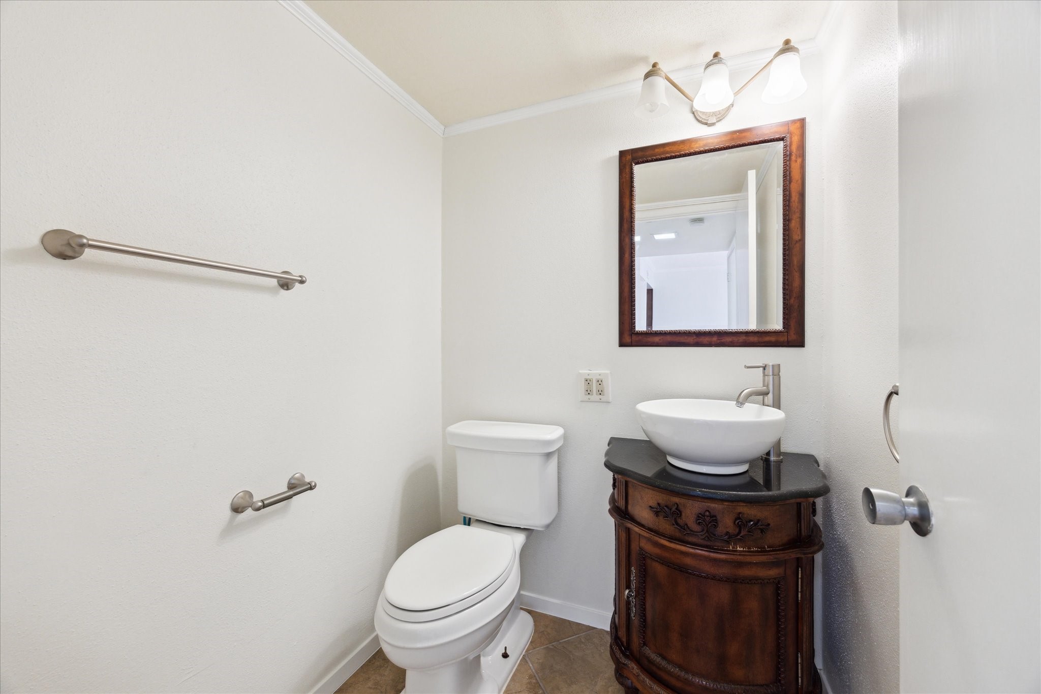 1801 Lavaca Street, Unit 2D Austin, TX 78701 - Photo 8 of 25 a bathroom with a toilet a sink and mirror