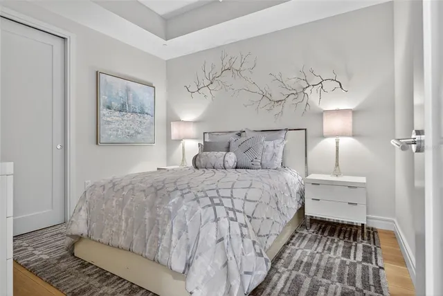 a bedroom with a bed and a painting on the wall