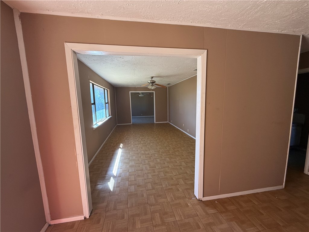 2871 Carr Road Beeville, TX 78102 - Photo 11 of 35 a view of a hallway with wooden floor and a living room