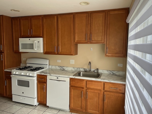 107 Horatio Boulevard Buffalo Grove, IL 60089 - Photo 2 of 27 a kitchen with stainless steel appliances granite countertop a stove a sink dishwasher and white cabinets with wooden floor