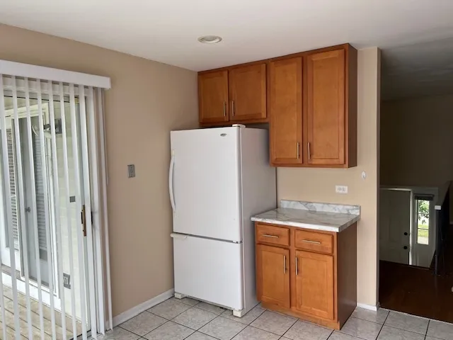 a white refrigerator freezer sitting in a kitchen