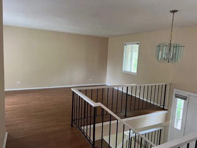 a view of hallway with window and stairs