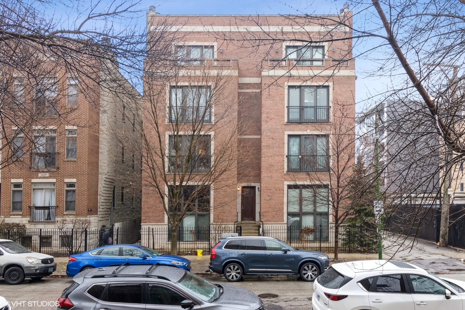 a couple of cars parked in front of a building