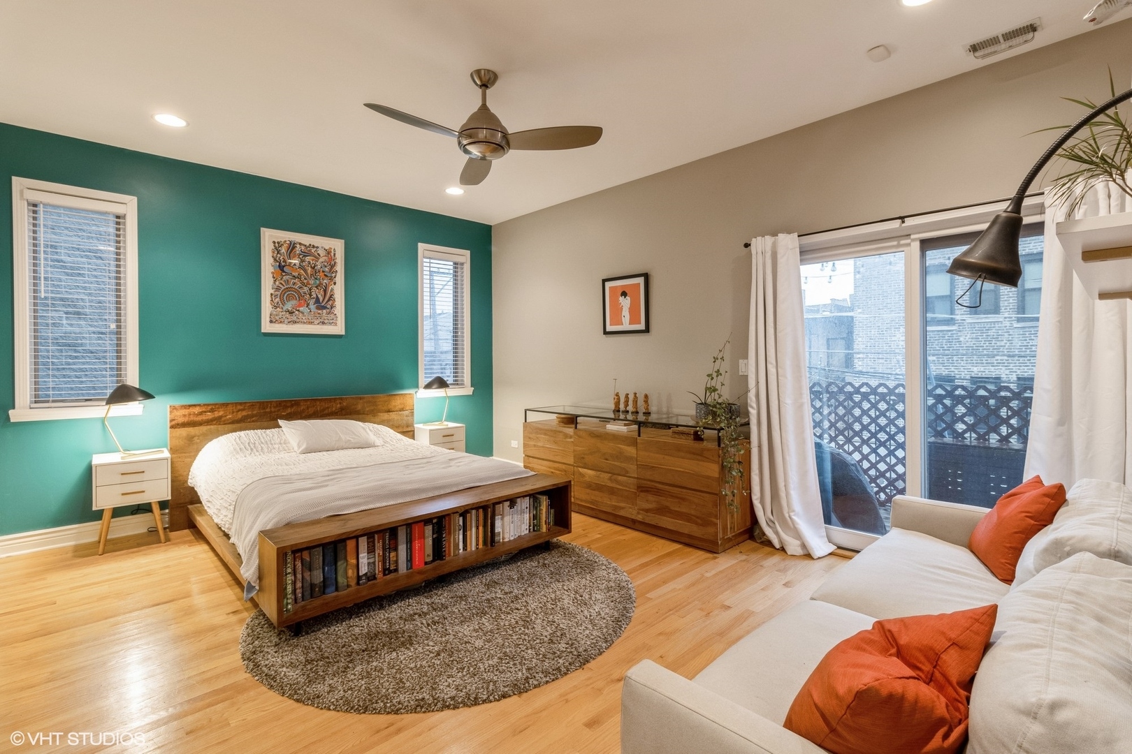 Undisclosed Address Chicago, IL 60647 - Photo 11 of 15 a bedroom with a large bed and a chandelier