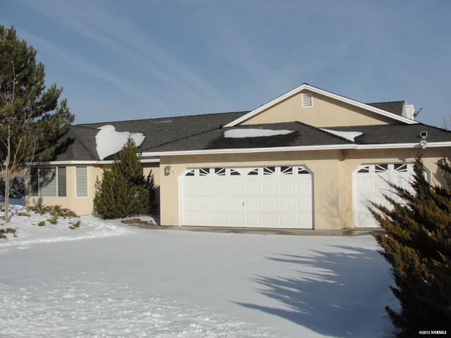 a front view of a house with a road