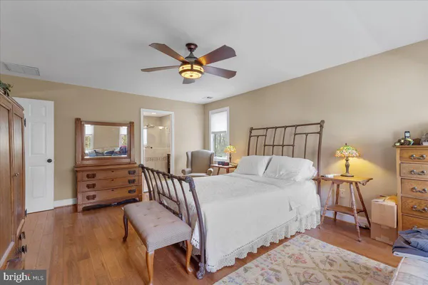 a bedroom with a bed couch and window