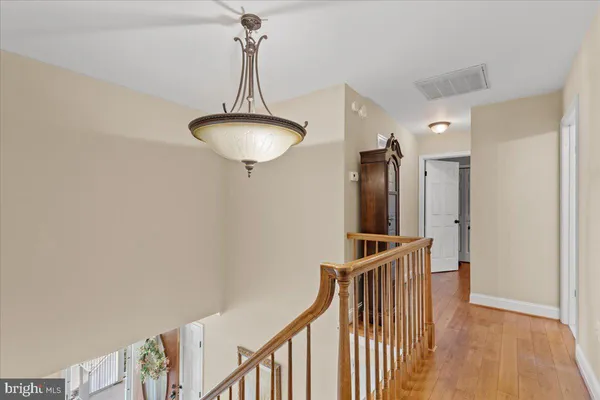 a bedroom with a bed and a flat tv screen on dresser