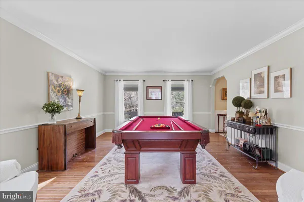 a living room with furniture a rug and a table